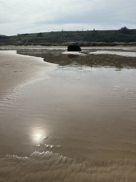 Low tide on Omaha Beach below the bluffs