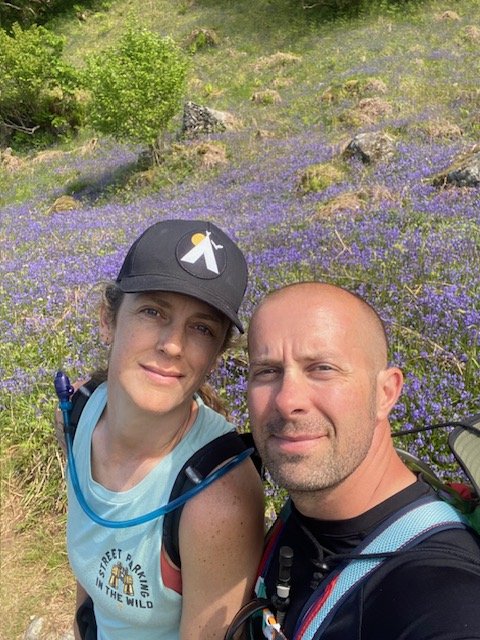Erin and Scott on a hillside of bluebells